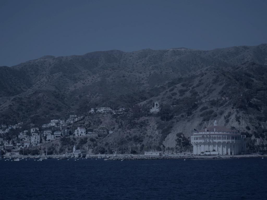 The Casino and Descanso Bay shoreline under a dark sky
